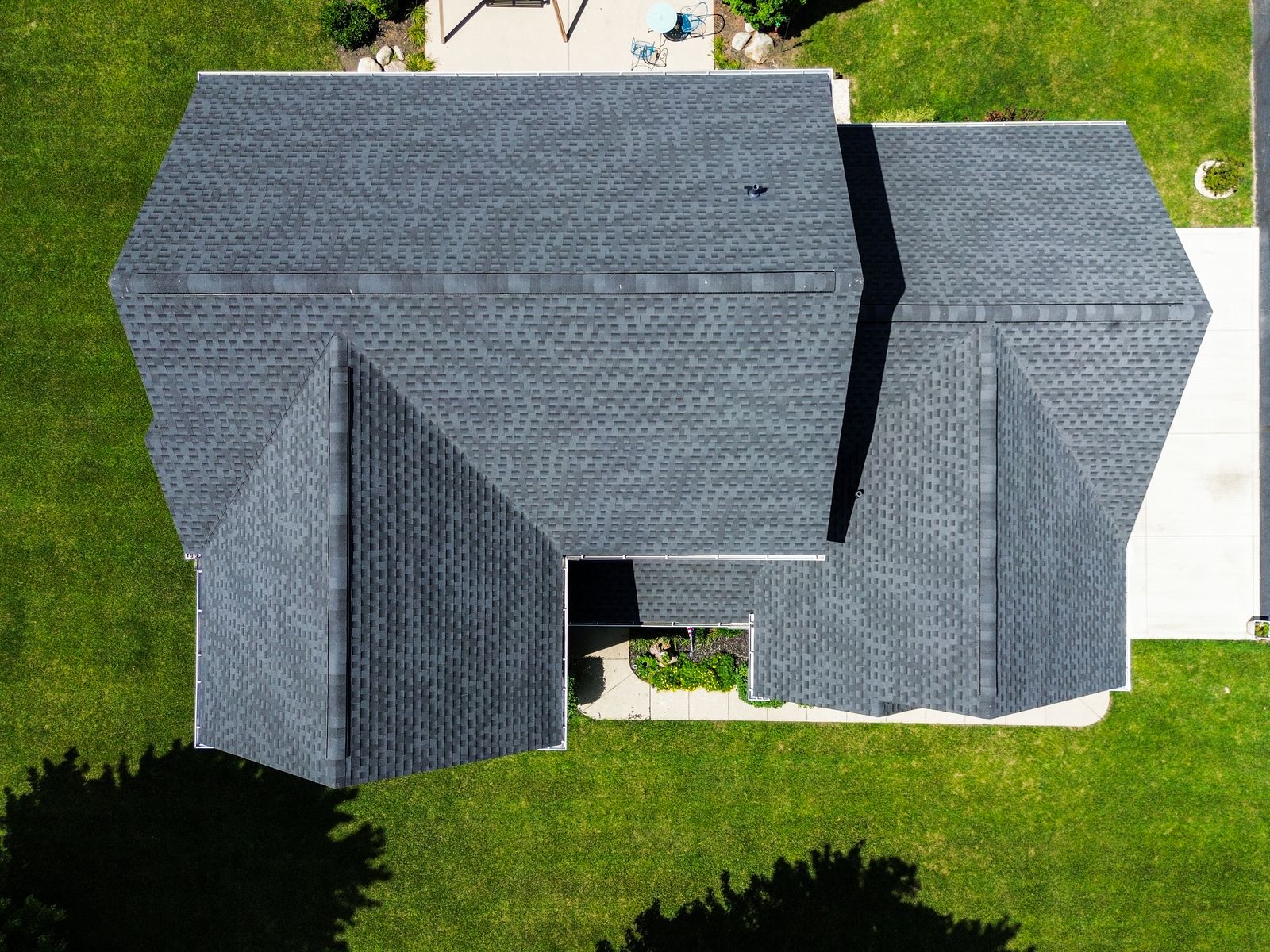 Top-down aerial of a finished Charcoal GAF Timberline HDZ field with ridge vent — Bellefontaine, Ohio