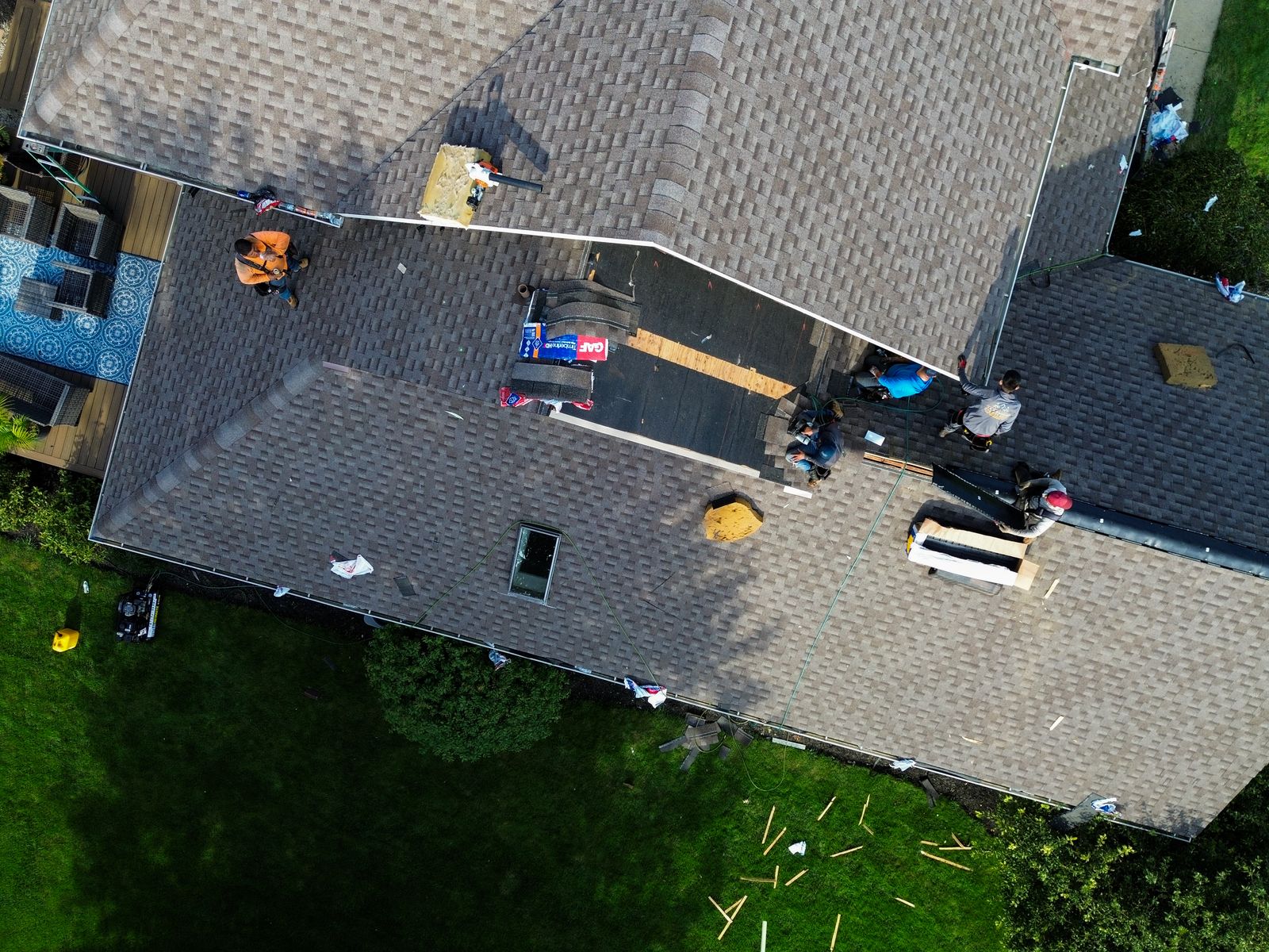 Peak One crew mid tear-off with GAF Timberline HDZ bundles staged and new sheathing installed — Hardin County, Ohio